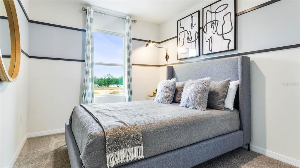 31191 Midnight Sun Way Wesley Chapel, FL 33545 - Photo 15 of 22 a bedroom with a bed and window