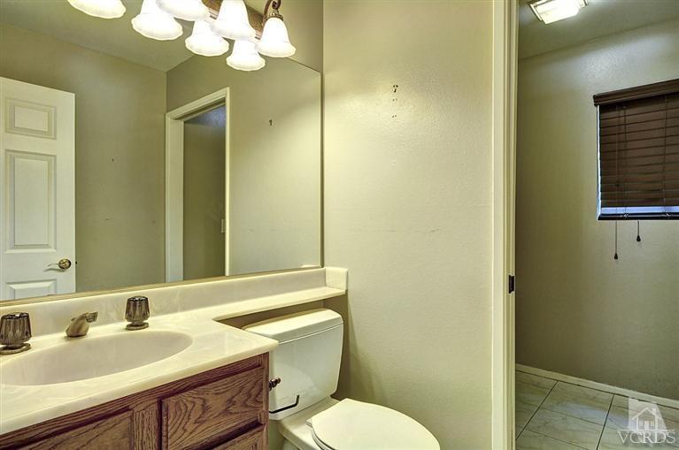 540 Fresh Meadows Road Simi Valley, CA 93065 - Photo 14 of 32 a bathroom with a granite countertop sink mirror and toilet