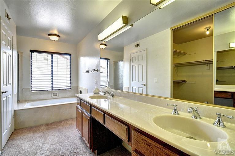 540 Fresh Meadows Road Simi Valley, CA 93065 - Photo 18 of 32 a bathroom with a granite countertop sink mirror double vanity and bathtub