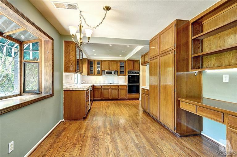 540 Fresh Meadows Road Simi Valley, CA 93065 - Photo 8 of 32 a view of a kitchen with wooden floor and a window