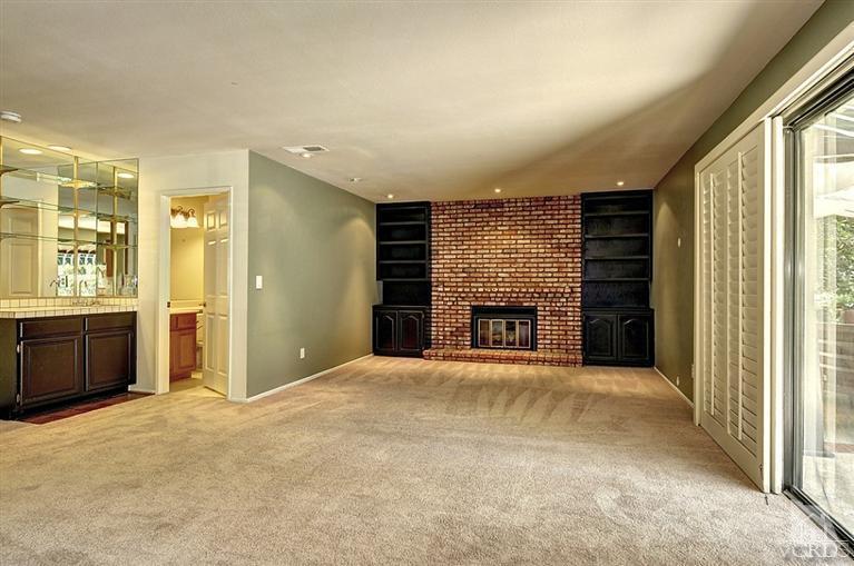 540 Fresh Meadows Road Simi Valley, CA 93065 - Photo 10 of 32 a view of an empty room with a fireplace and a window