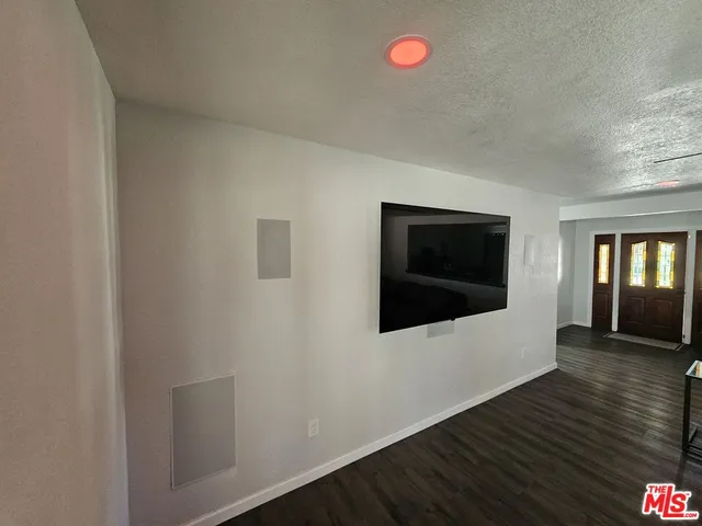 a kitchen with a dining table chairs and refrigerator