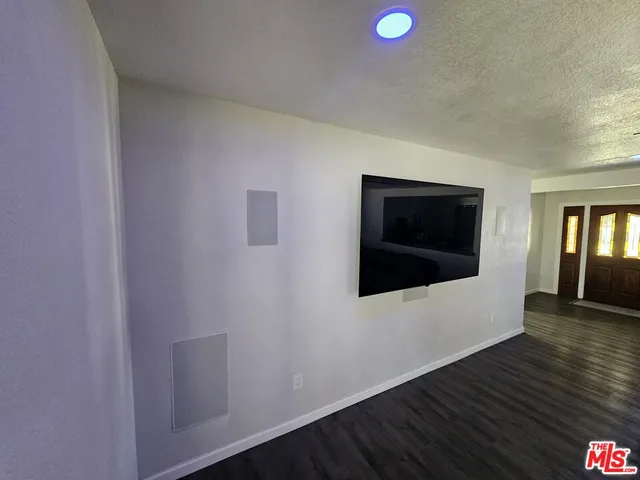 a living room with furniture a potted plant and a large window