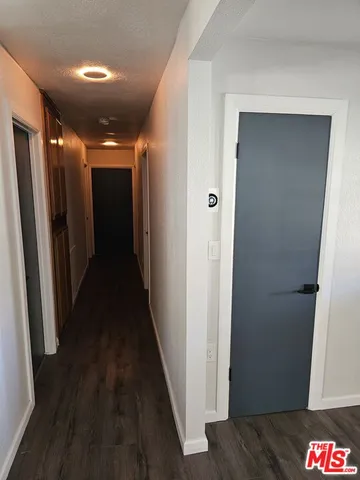 a view of a kitchen center island wooden floor and living room
