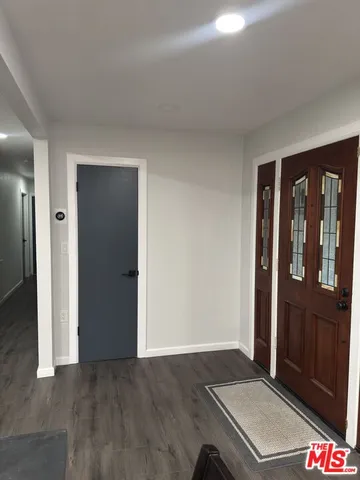 a view of a livingroom with furniture and a window