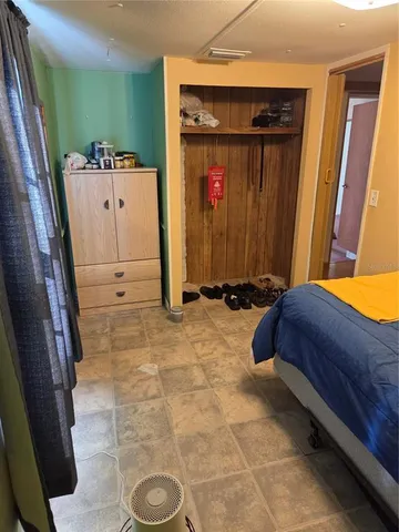 a bedroom with a bed and a mirror