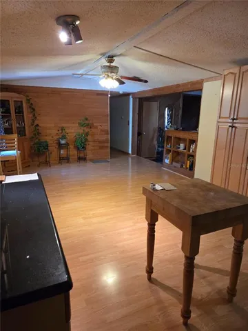 a living room with pool table furniture and a flat screen tv