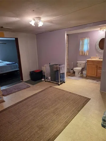 a bedroom with a bed and a couch