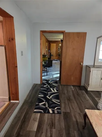 a bedroom with wooden floor and a sink