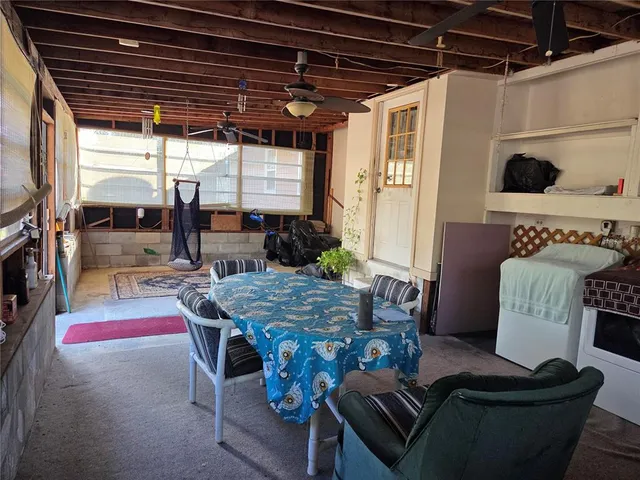 a dining room with furniture and a floor to ceiling window