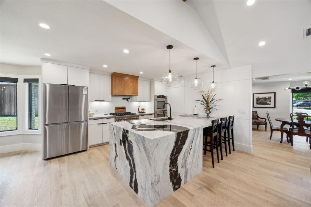 14406 Overview Drive Dallas, TX 75254 - Photo 11 of 39 a large kitchen with a table and chairs