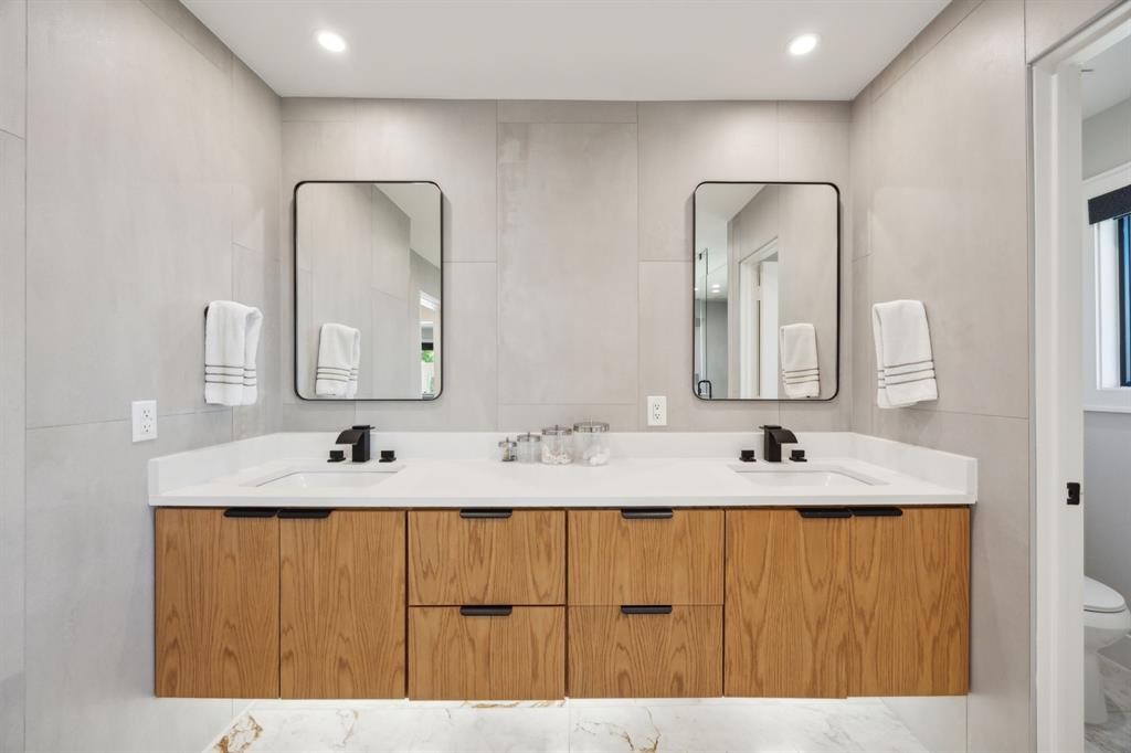 14406 Overview Drive Dallas, TX 75254 - Photo 19 of 39 a bathroom with a double vanity sink and a mirror