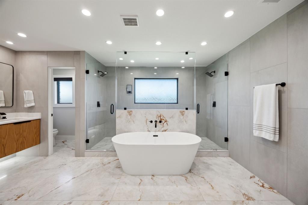 14406 Overview Drive Dallas, TX 75254 - Photo 20 of 39 a bathroom with a bathtub and shower