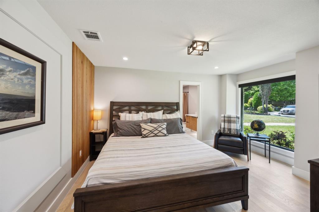 14406 Overview Drive Dallas, TX 75254 - Photo 22 of 39 a bedroom with a balcony a bed and a painting on the wall