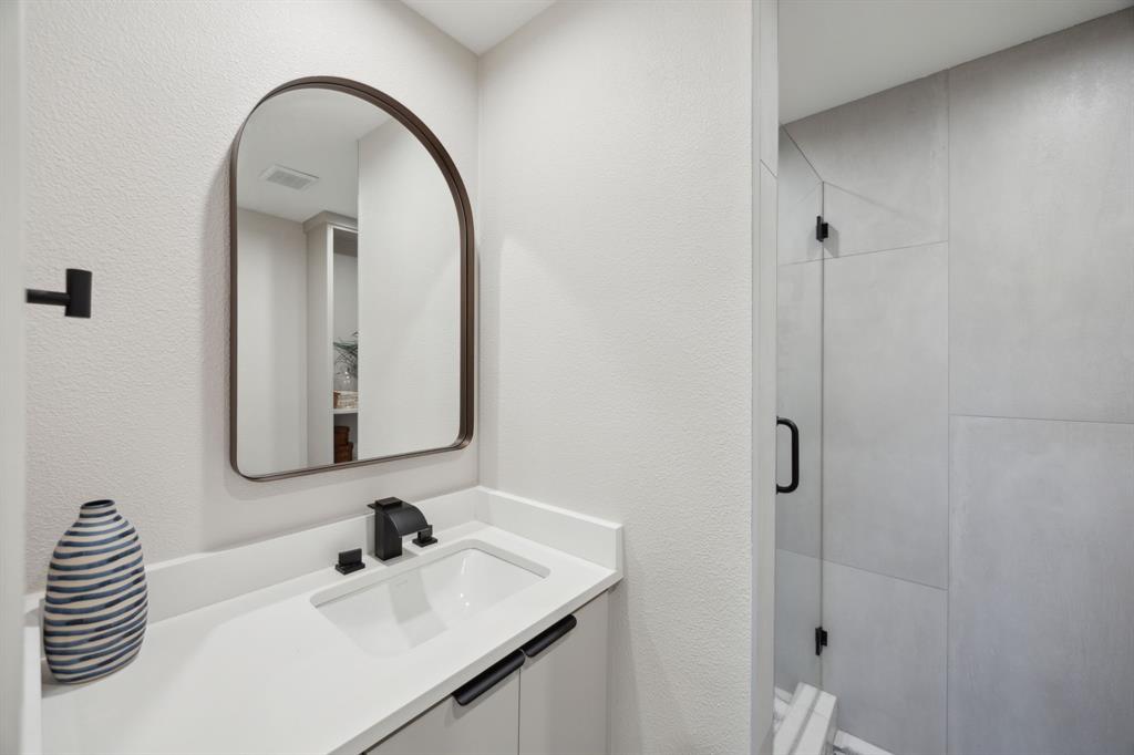14406 Overview Drive Dallas, TX 75254 - Photo 25 of 39 a bathroom with a sink and a mirror