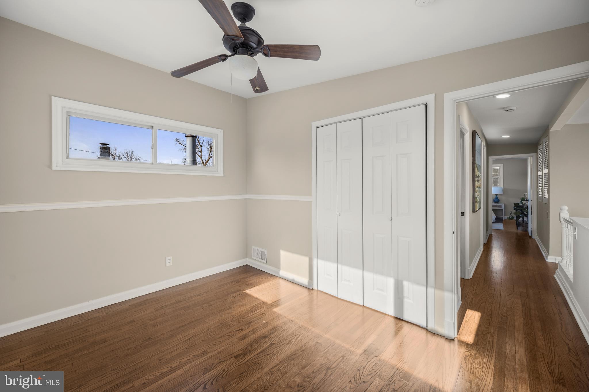 3412 Milford Mill Road Baltimore, MD 21244 - Photo 16 of 28 wooden floor in an empty room with a window