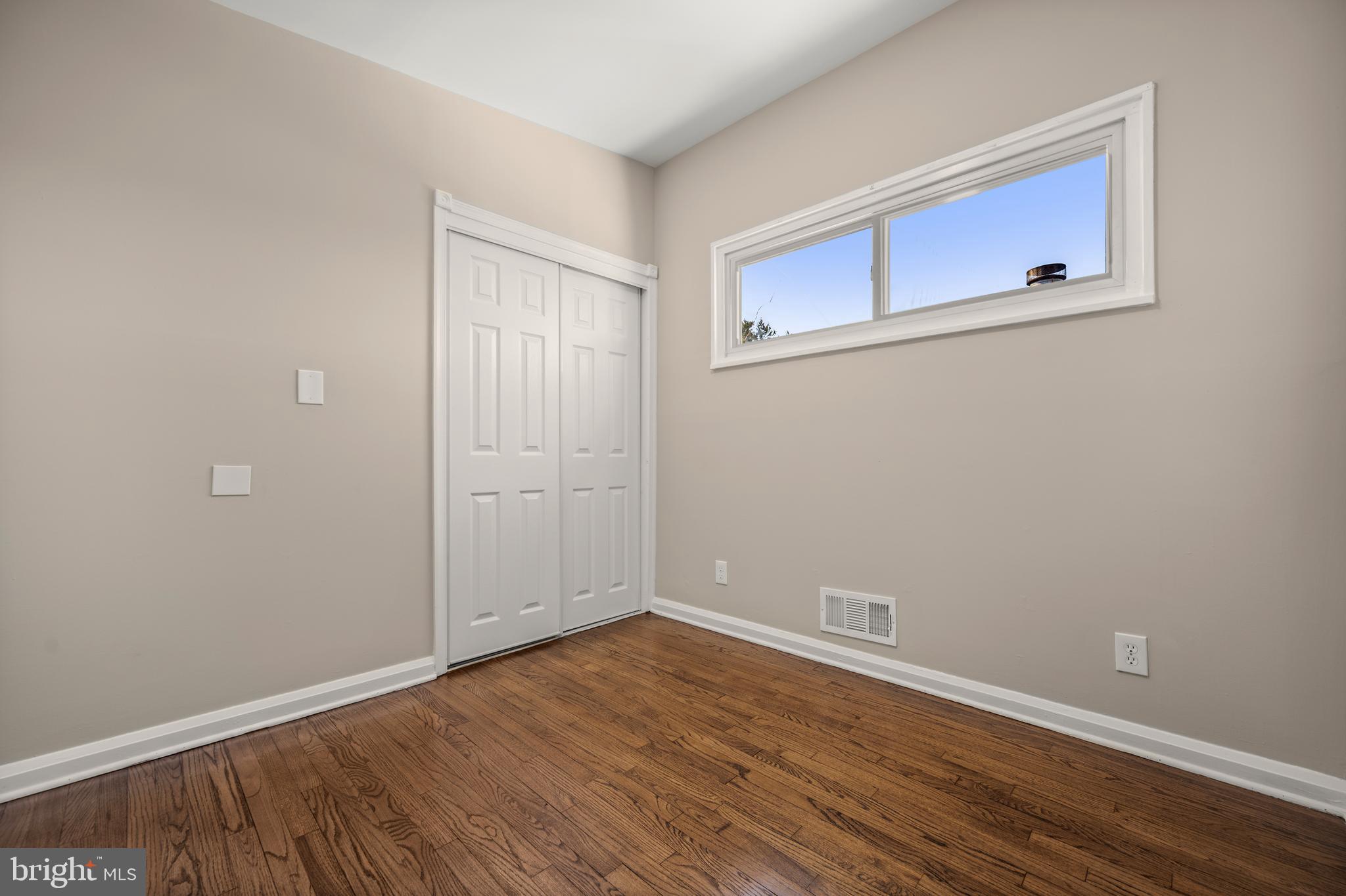 3412 Milford Mill Road Baltimore, MD 21244 - Photo 19 of 28 a view of an empty room with wooden floor