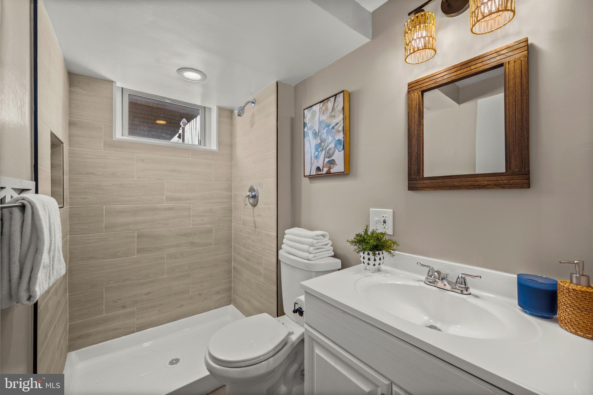 3412 Milford Mill Road Baltimore, MD 21244 - Photo 22 of 28 a bathroom with a sink mirror toilet and shower