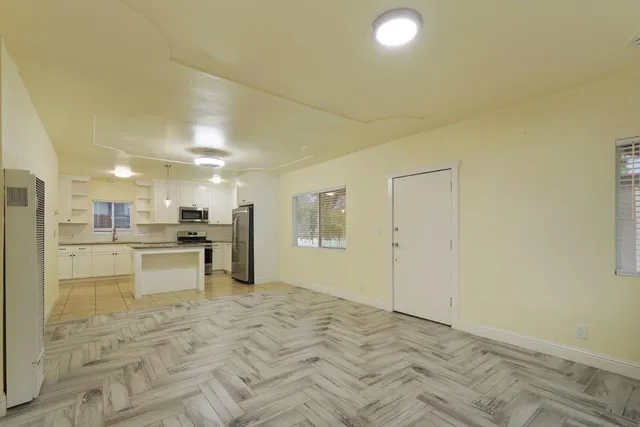 a view of kitchen with refrigerator stove microwave and cabinets