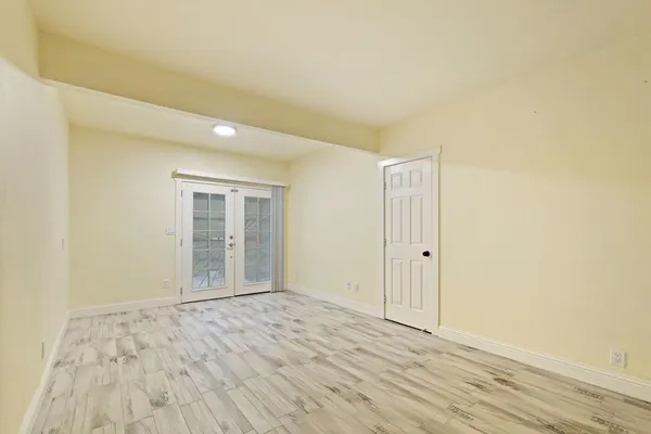 a view of an empty room and wooden floor