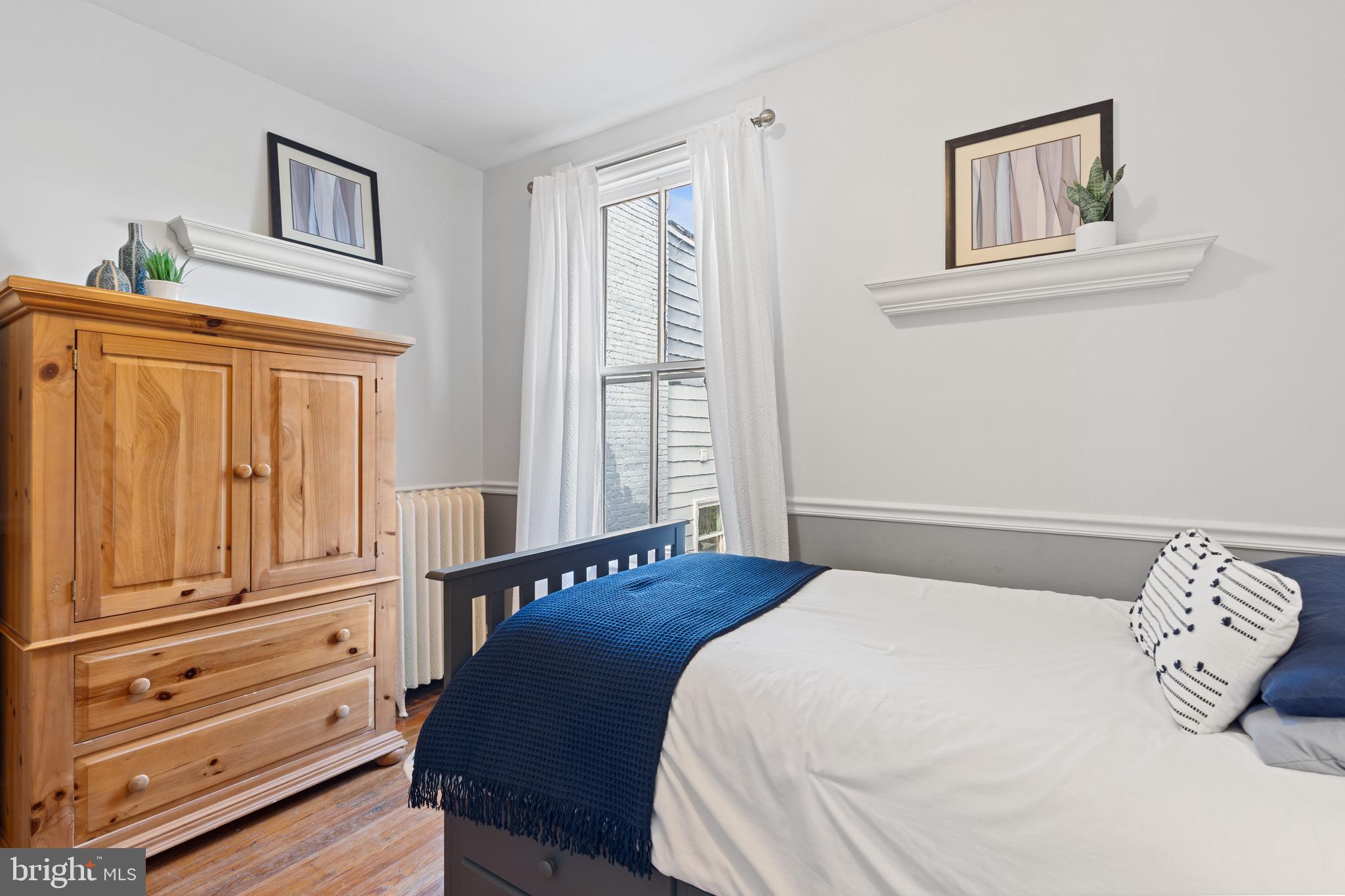 207 10th Street Northeast Washington, DC 20002 - Photo 33 of 40 a bedroom with a bed and a window
