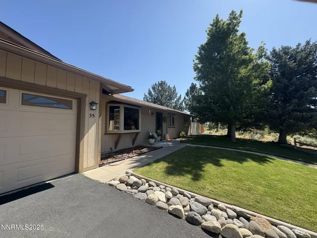 a view of a house with swimming pool and sitting area