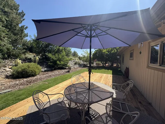 a view of a swimming pool and chairs under an umbrella