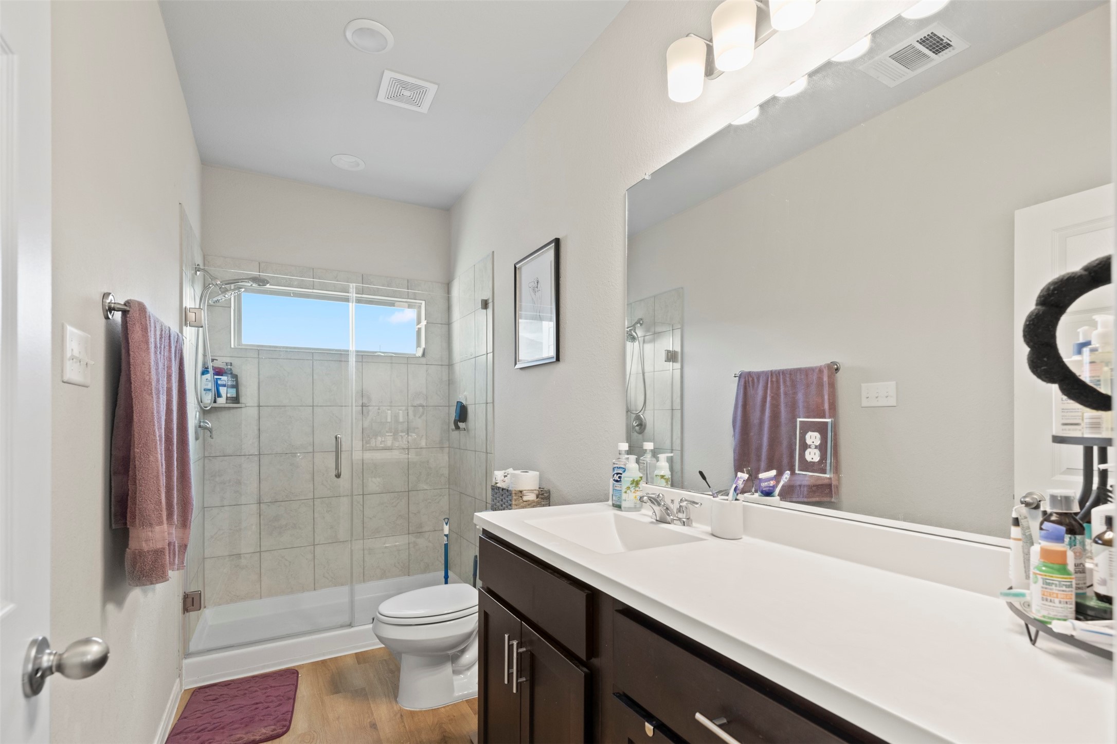 6444 Wenlock Drive Houston, TX 77048 - Photo 16 of 21 a bathroom with a sink a toilet a mirror and shower