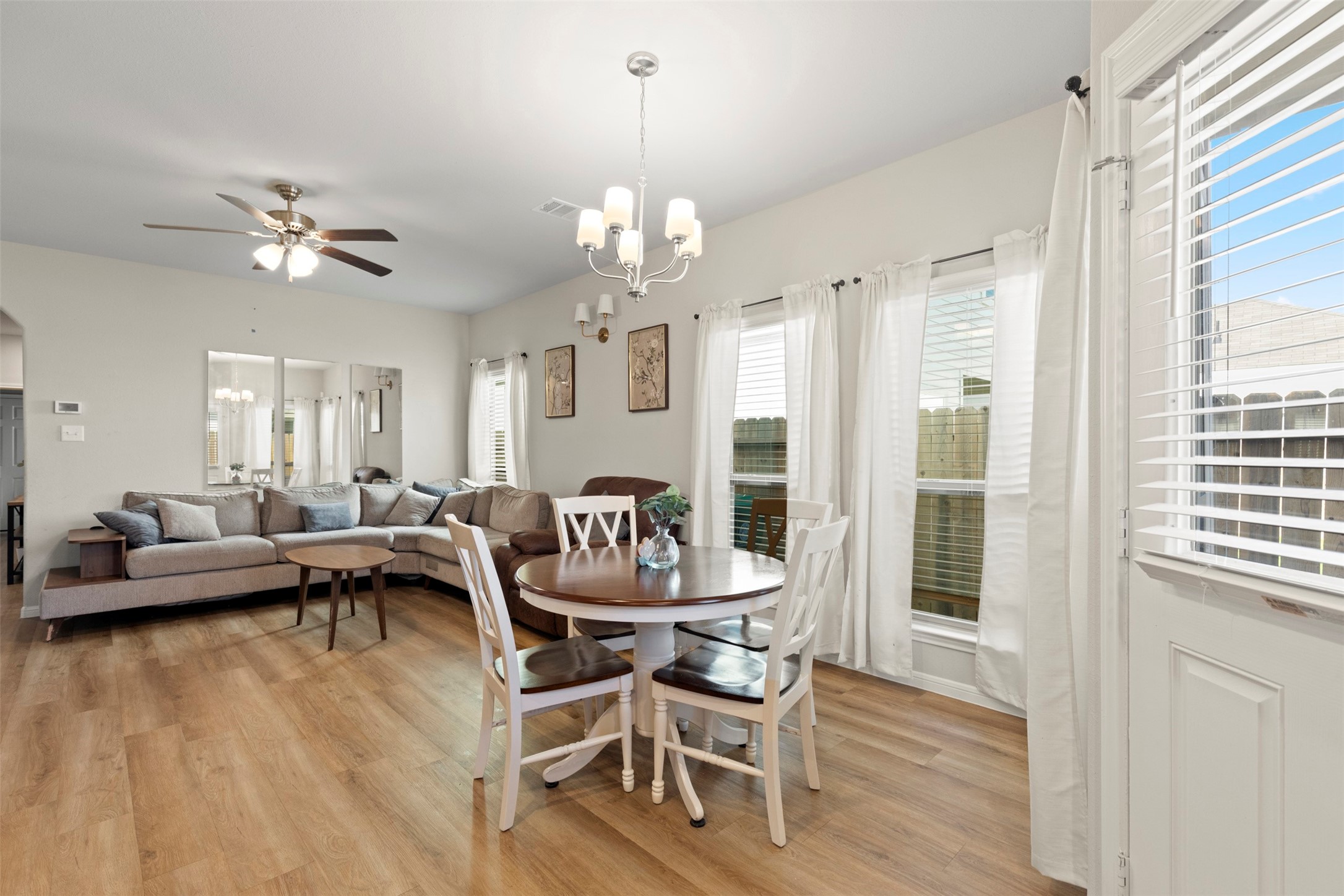 6444 Wenlock Drive Houston, TX 77048 - Photo 8 of 21 a living room with furniture a chandelier and a chandelier