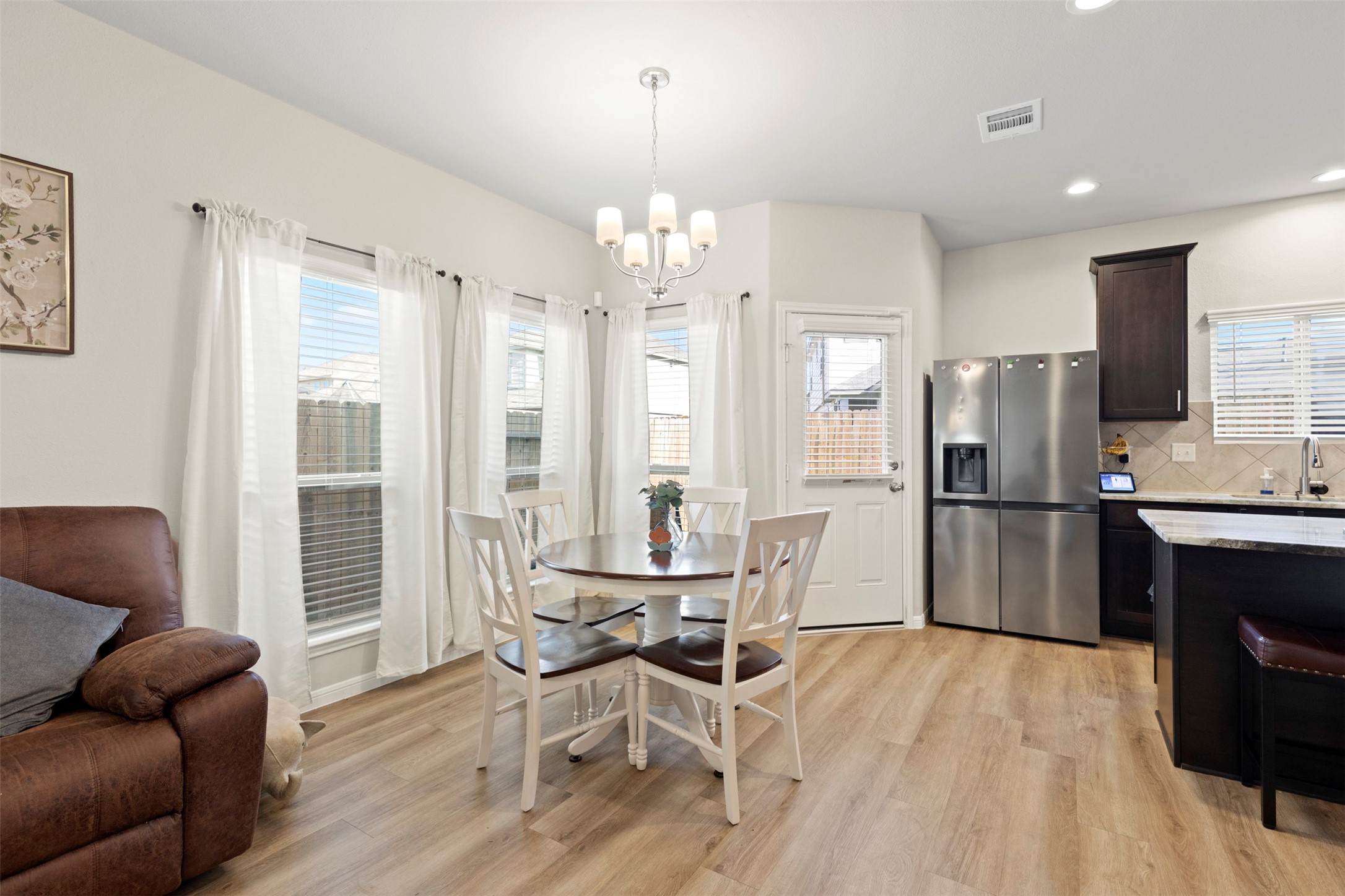 6444 Wenlock Drive Houston, TX 77048 - Photo 9 of 21 a dining room with furniture and a chandelier