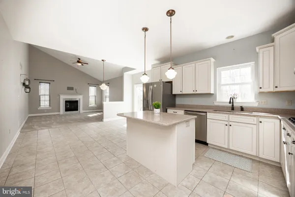 a kitchen with stainless steel appliances granite countertop a sink and cabinets