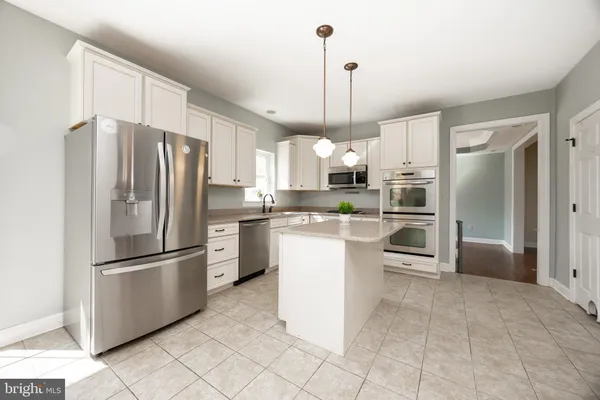 a kitchen with kitchen island white cabinets appliances and cabinets
