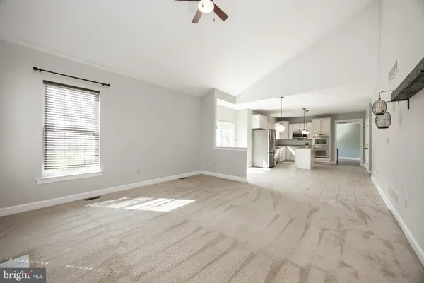 a view of empty room with a fireplace and window