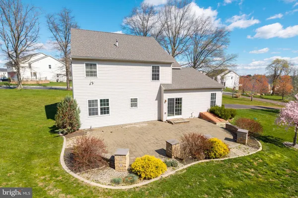 a view of a house with backyard and sitting area