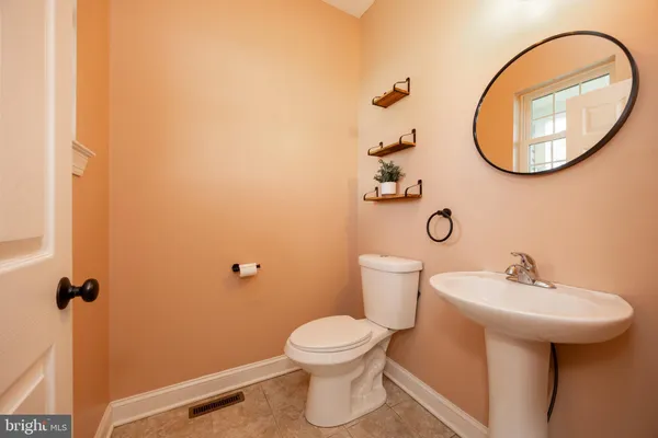 a bathroom with a sink mirror and toilet