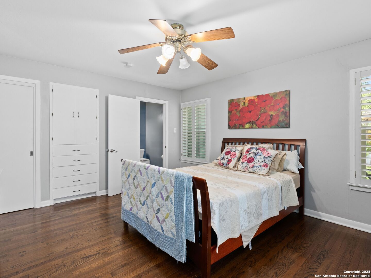 215 Tophill Road San Antonio, TX 78209 - Photo 19 of 29 a bedroom with bed and a chandelier
