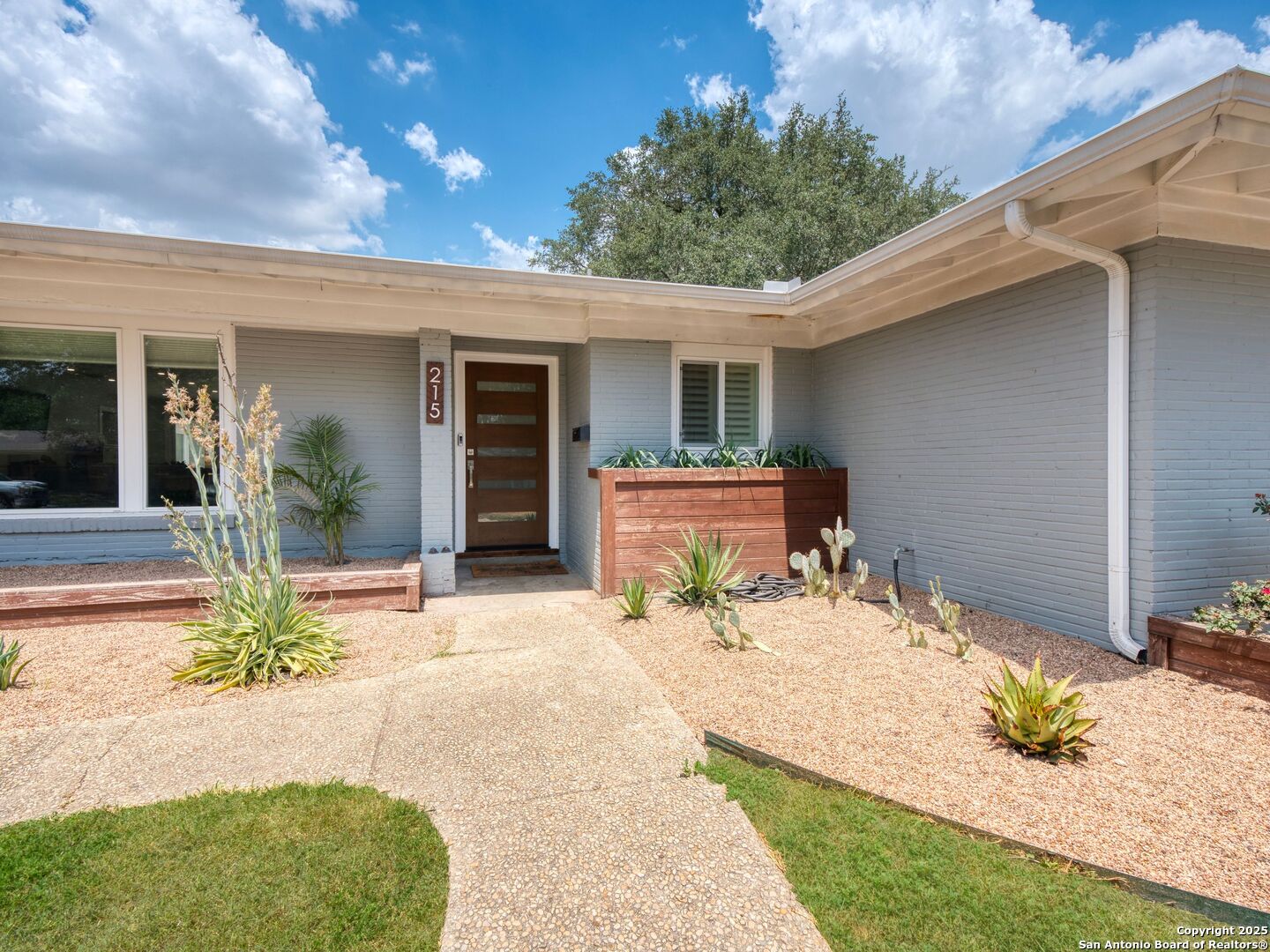 215 Tophill Road San Antonio, TX 78209 - Photo 2 of 29 a front view of a house with a patio