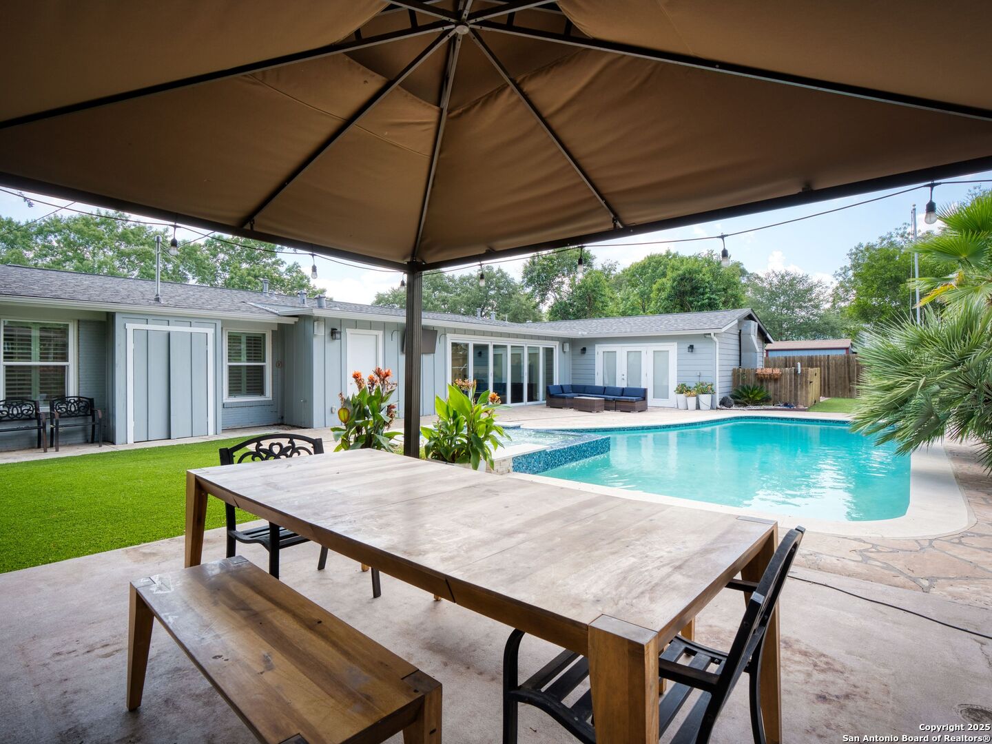 215 Tophill Road San Antonio, TX 78209 - Photo 25 of 29 a view of a patio with table and chairs under an umbrella