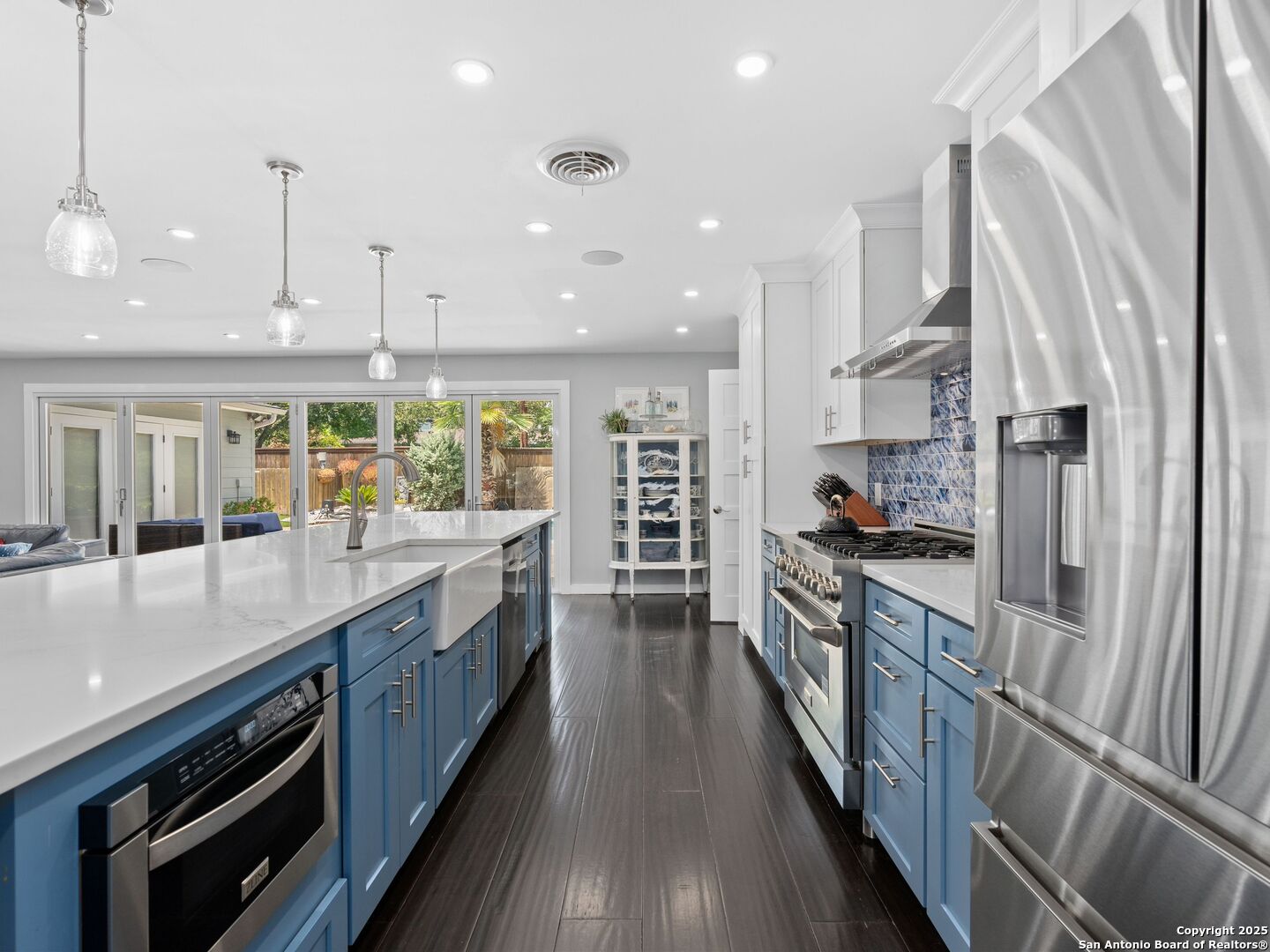 215 Tophill Road San Antonio, TX 78209 - Photo 7 of 29 a large kitchen with stainless steel appliances a large counter top a stove and a wooden floors