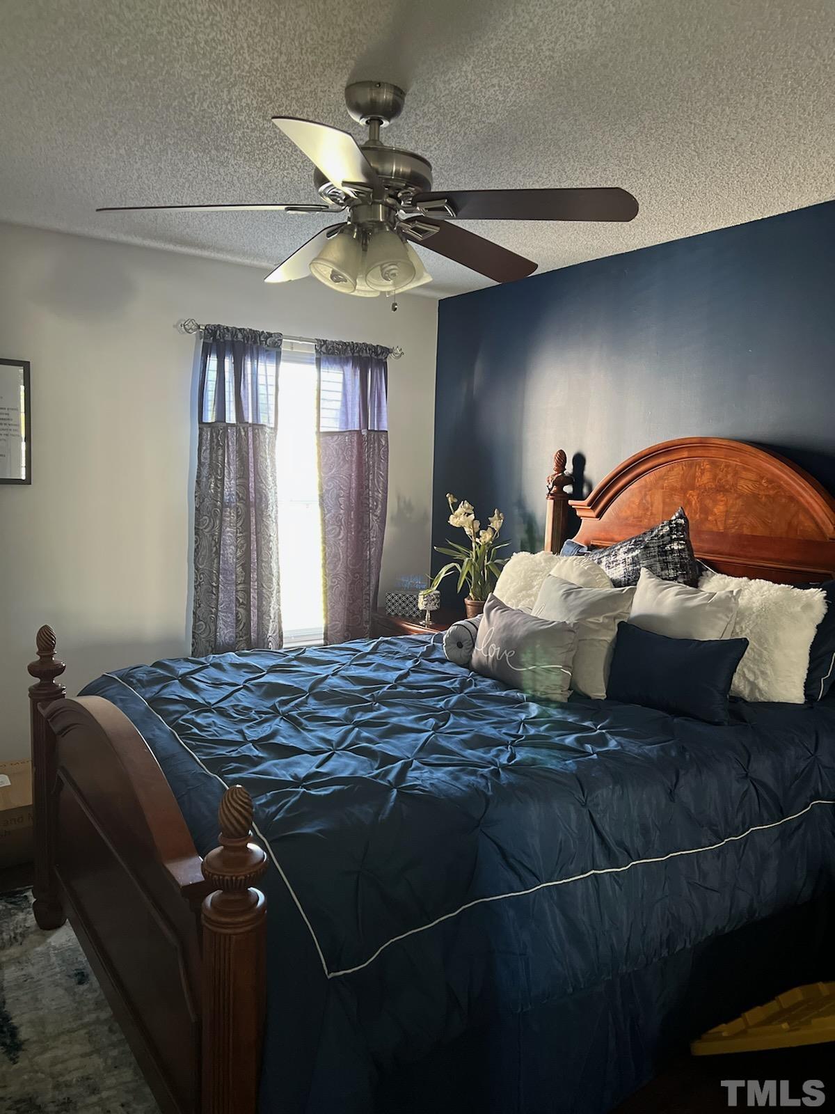 3316 Marshlane Way Raleigh, NC 27610 - Photo 4 of 7 a bedroom with a bed and ceiling fan