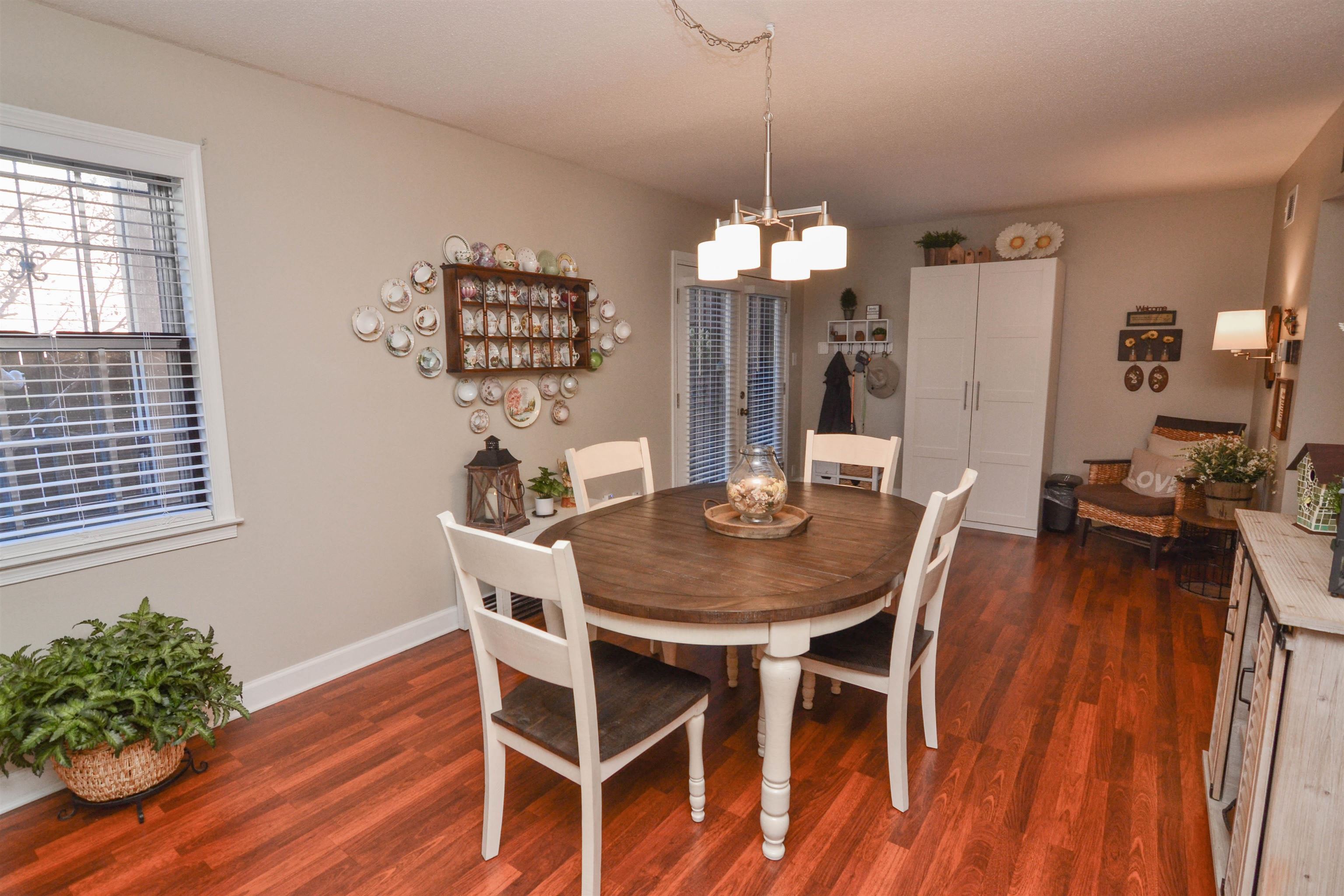 5676 Quince Road, Unit 11 Memphis, TN 38119 - Photo 7 of 22 a view of a dining room with furniture wooden floor and chandelier