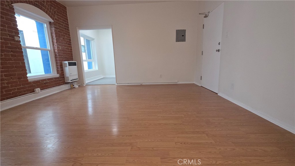 33408 Sunset Los Angeles, CA 90026 - Photo 3 of 11 a view of an empty room with glass door and wooden floor