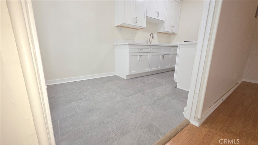 33408 Sunset Los Angeles, CA 90026 - Photo 9 of 11 a room with granite countertop white cabinets and sink