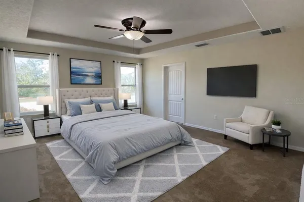 a bedroom with a bed couch and a window