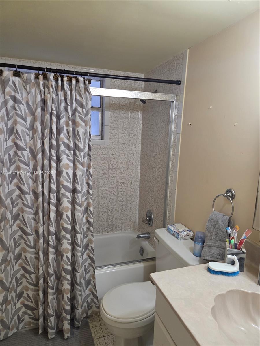 14165 Southwest 87th Street, Unit D103 Miami, FL 33183 - Photo 14 of 41 a bathroom with a sink toilet and shower