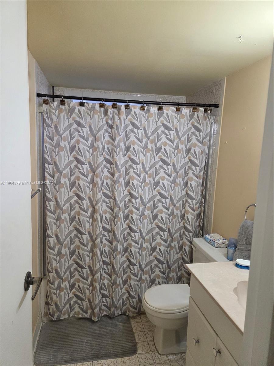 14165 Southwest 87th Street, Unit D103 Miami, FL 33183 - Photo 15 of 41 a bathroom with a toilet and a sink