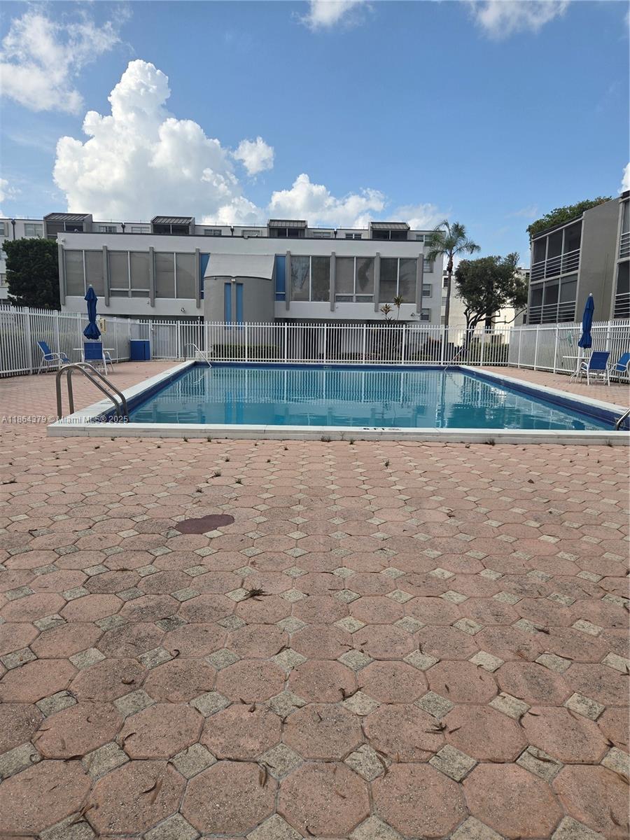 14165 Southwest 87th Street, Unit D103 Miami, FL 33183 - Photo 20 of 41 a view of residential houses with yard and ocean view