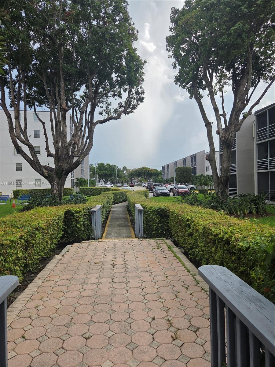 14165 Southwest 87th Street, Unit D103 Miami, FL 33183 - Photo 21 of 41 a view of a park with large trees