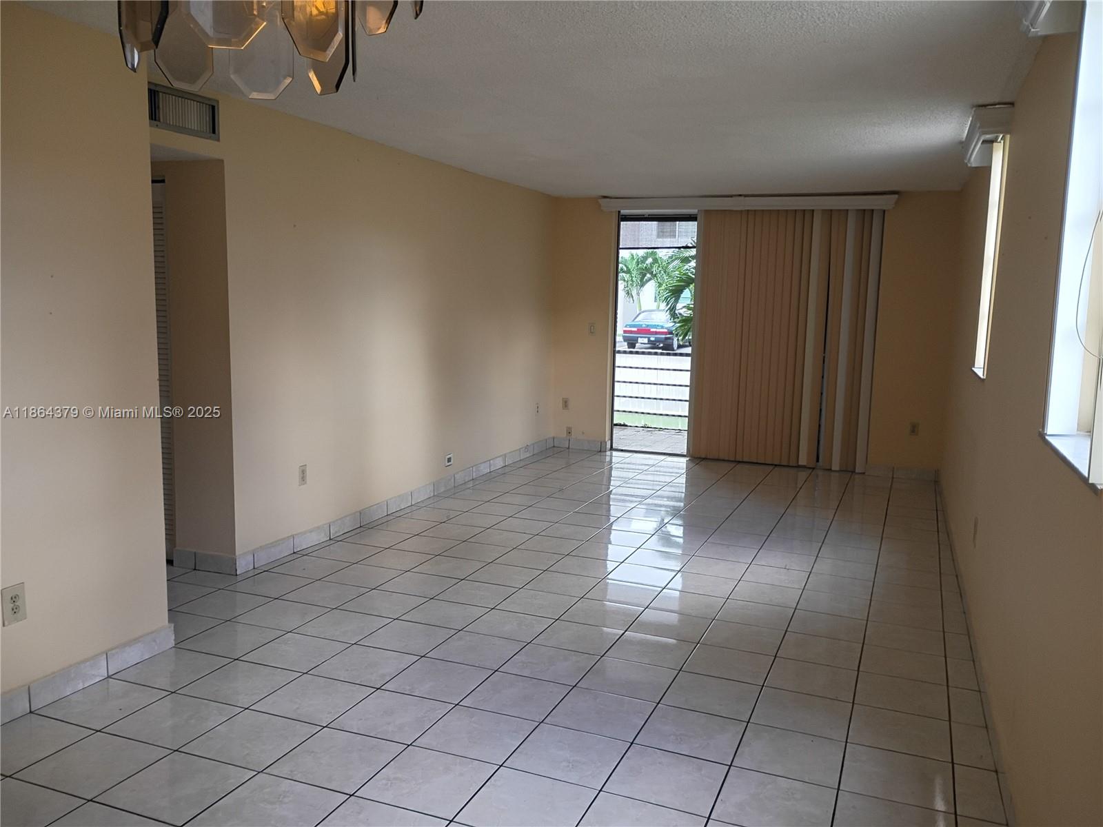 14165 Southwest 87th Street, Unit D103 Miami, FL 33183 - Photo 24 of 41 an empty room with windows