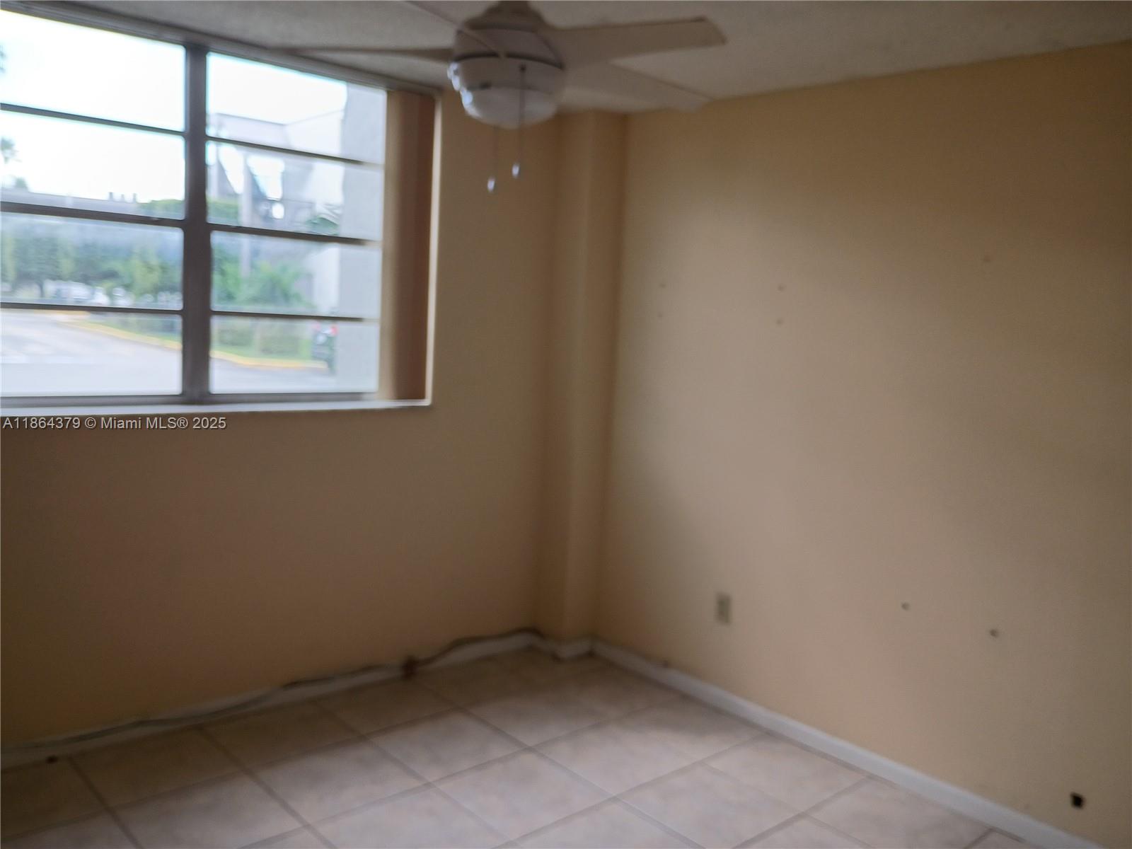 14165 Southwest 87th Street, Unit D103 Miami, FL 33183 - Photo 26 of 41 an empty room with a window